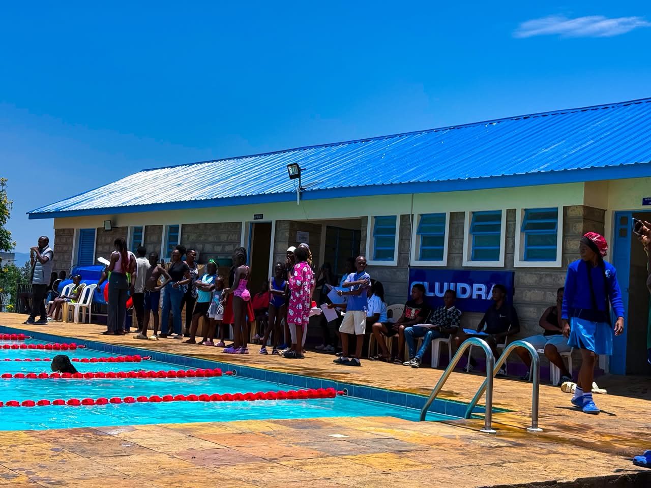 Spectators and officials gathered at the poolside