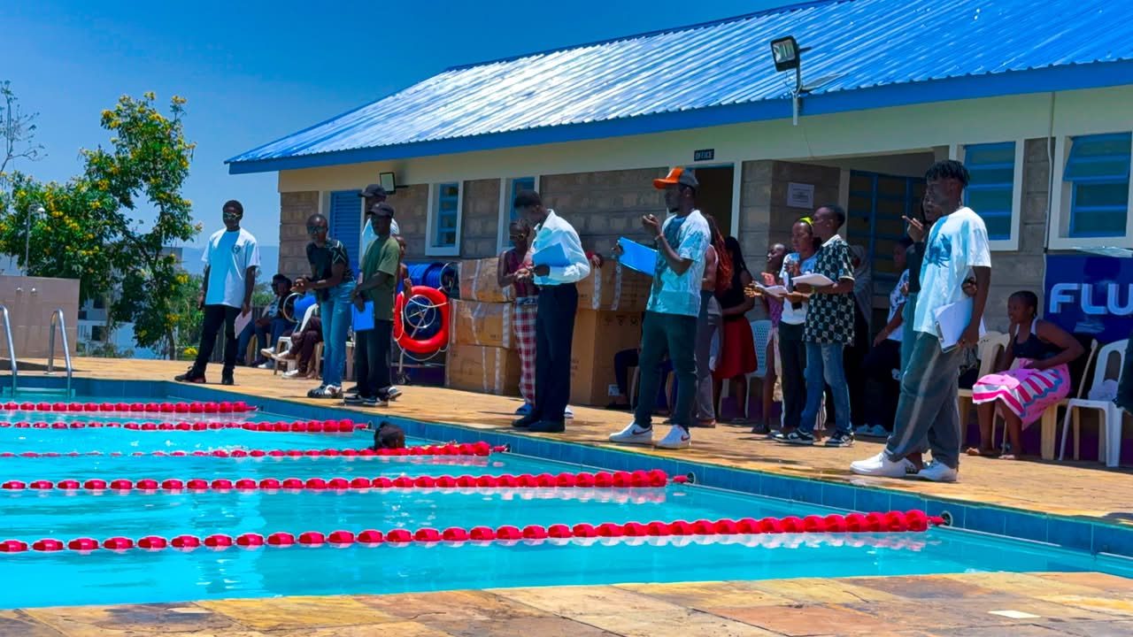 Officials and spectators watching the heats poolside